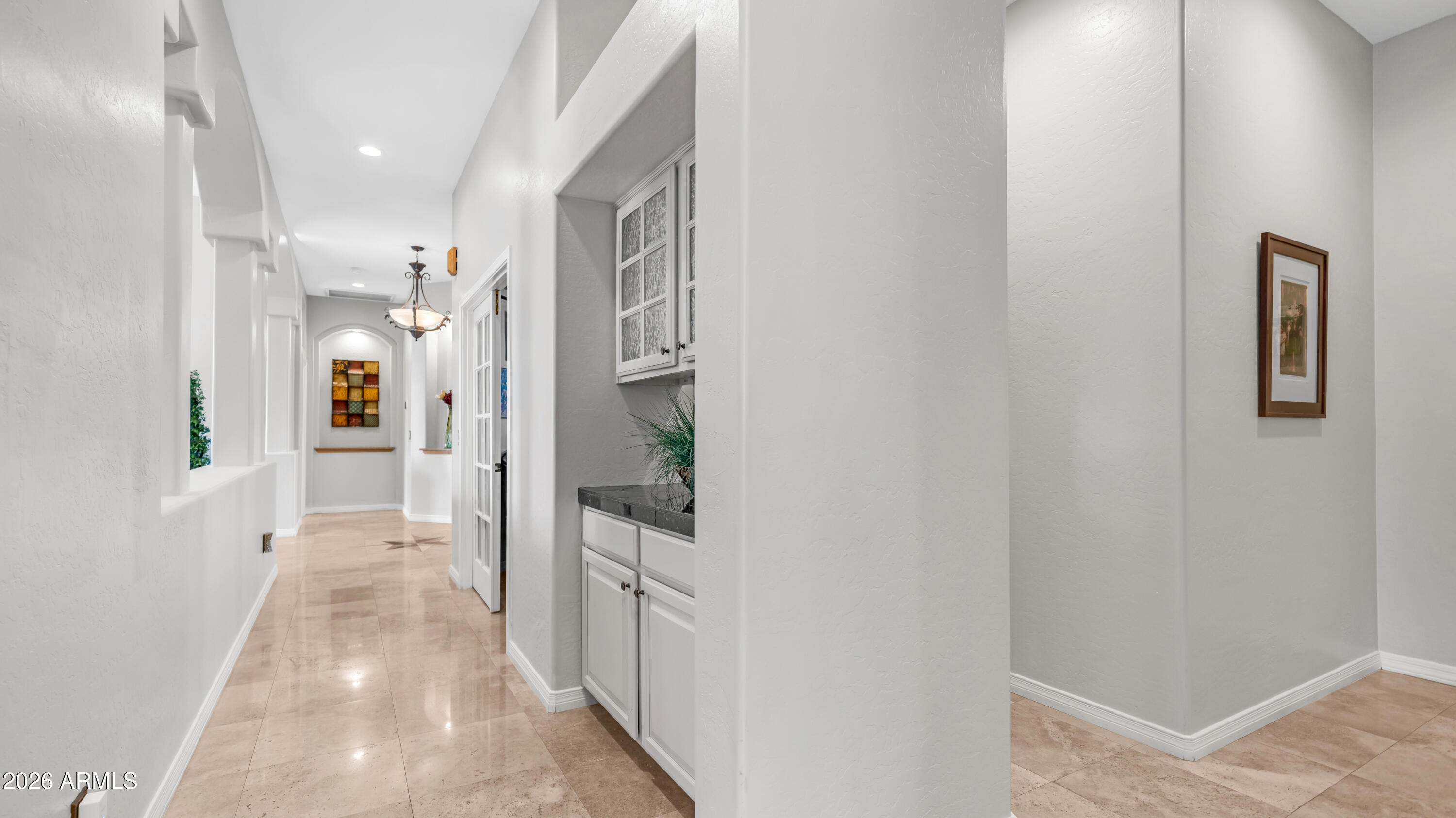 4055 North Recker Road, Unit 50 Mesa, AZ 85215 - Photo 27 of 77 a view of a hallway with wooden floor