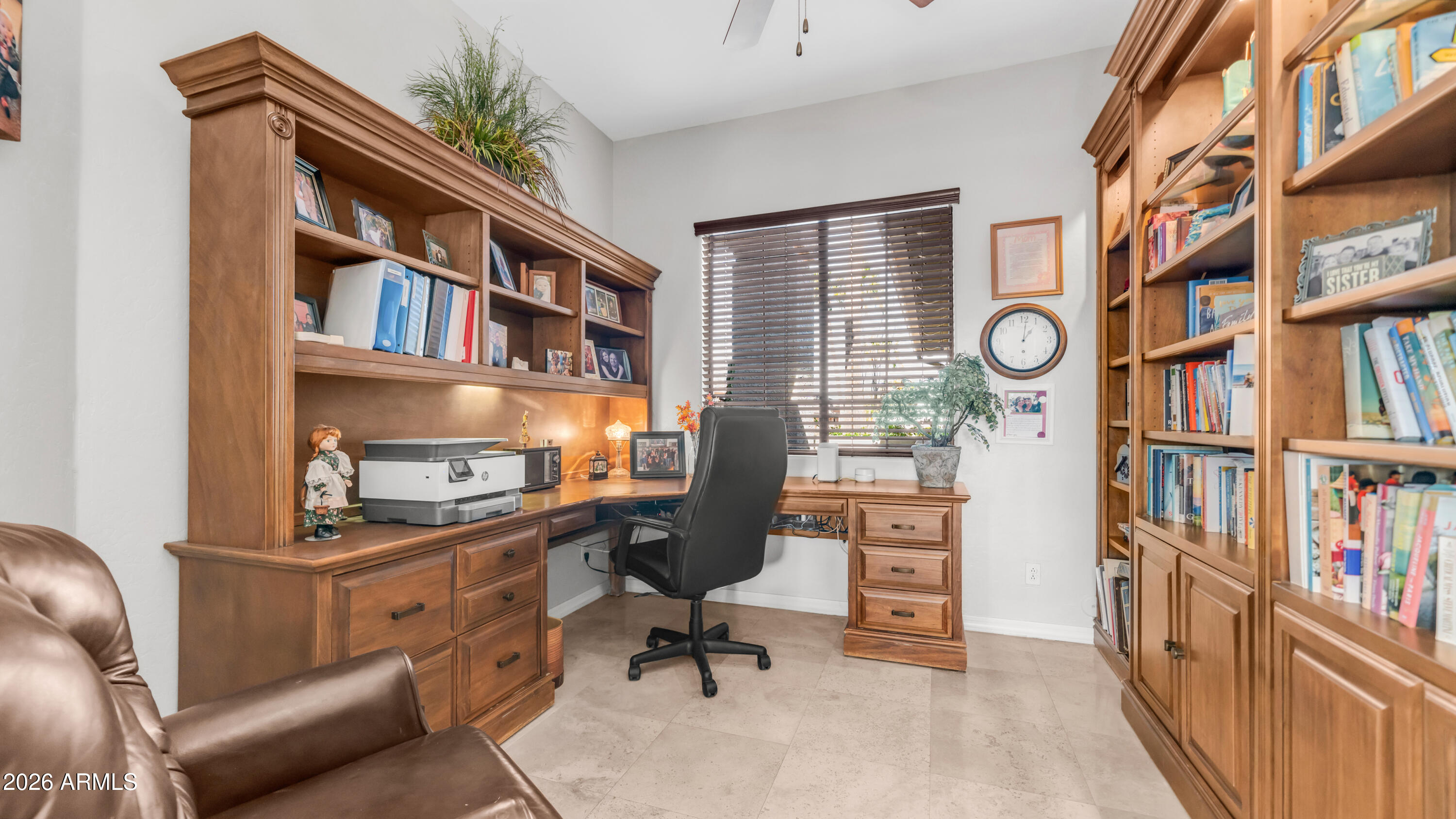 4055 North Recker Road, Unit 50 Mesa, AZ 85215 - Photo 29 of 77 a view of a workspace with furniture and a book shelf