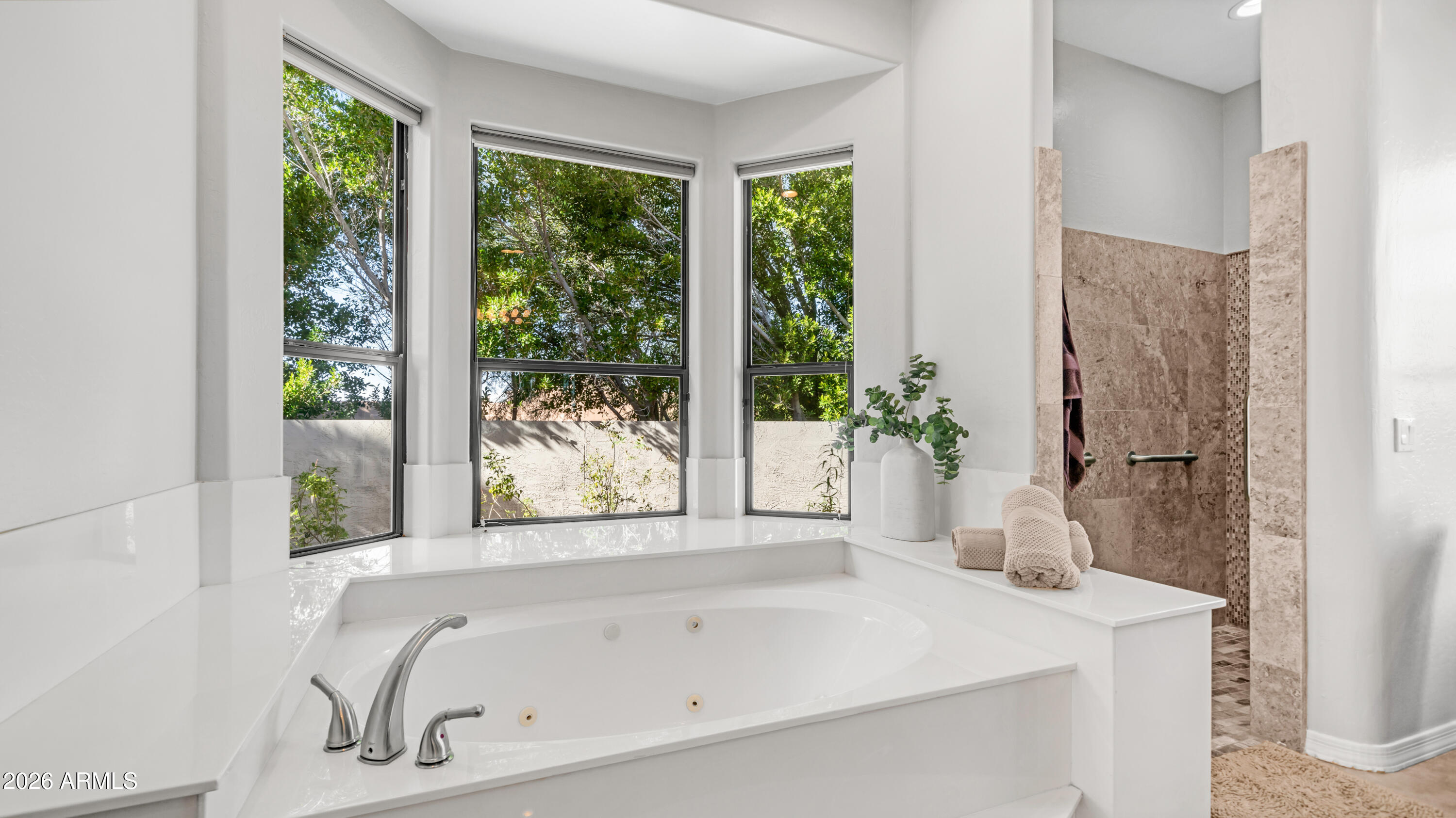 4055 North Recker Road, Unit 50 Mesa, AZ 85215 - Photo 35 of 77 a bathroom with a bathtub and a sink