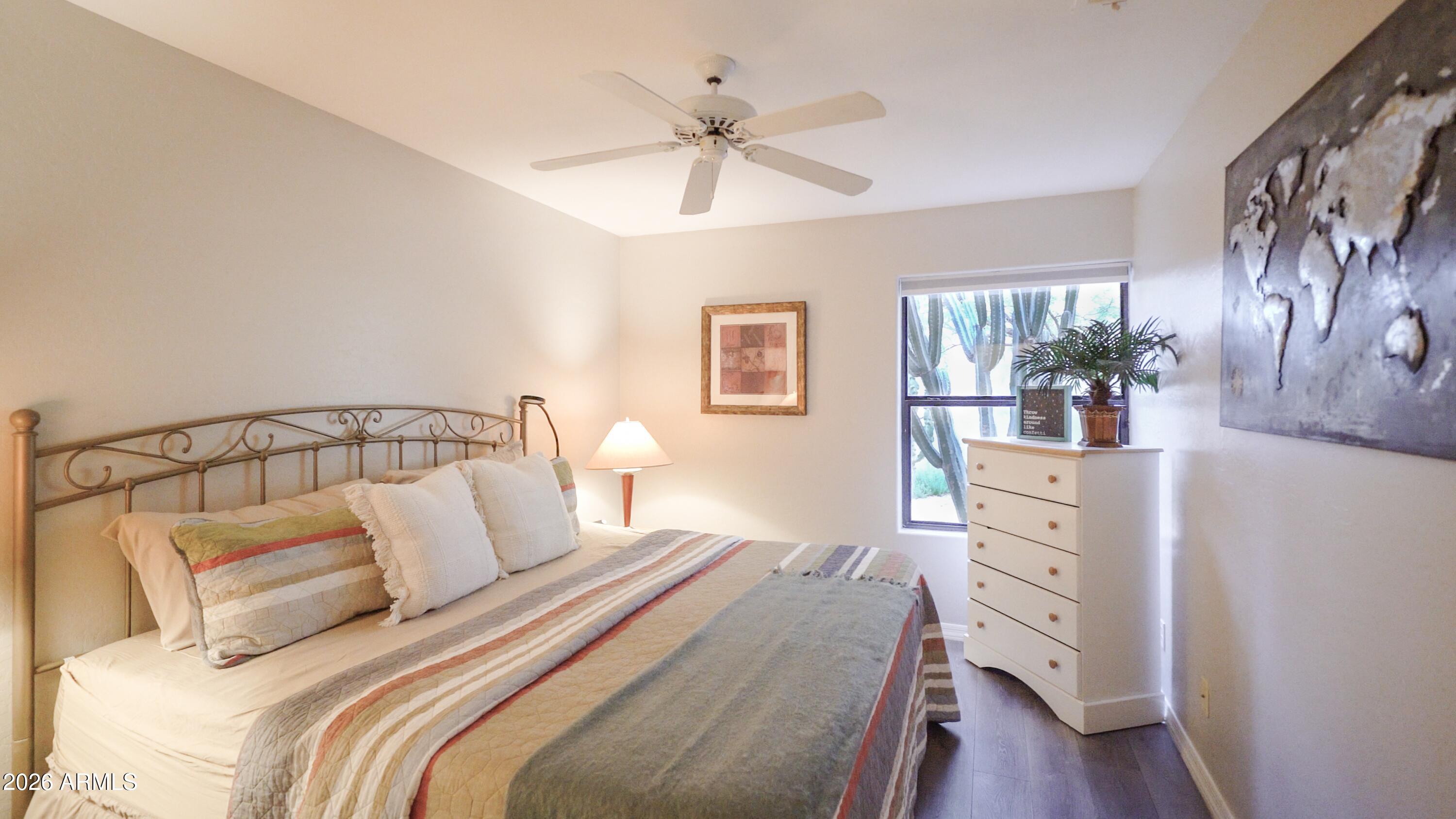 4055 North Recker Road, Unit 50 Mesa, AZ 85215 - Photo 39 of 77 a bedroom with a bed and wooden floor