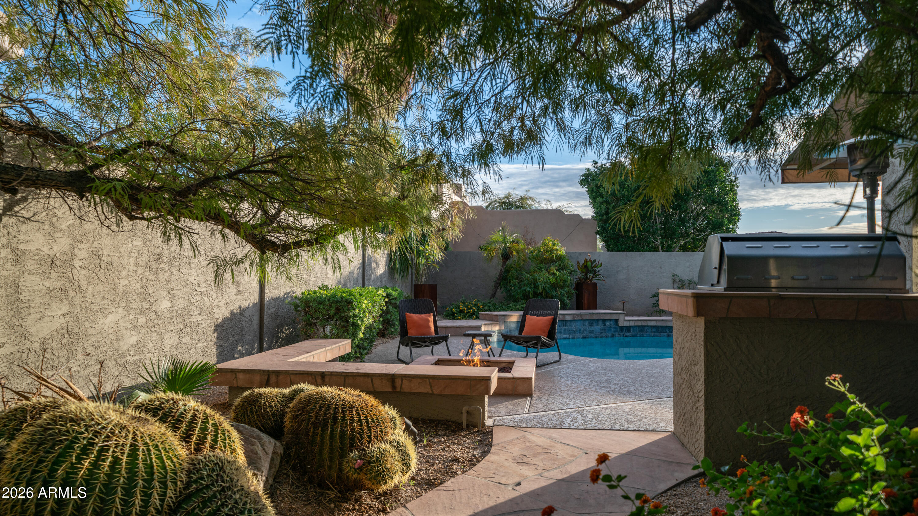 4055 North Recker Road, Unit 50 Mesa, AZ 85215 - Photo 52 of 77 a view of backyard with outdoor seating and trees