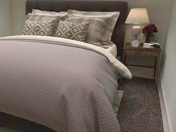 a bedroom with a bed and a window