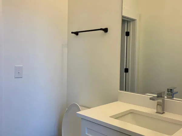 a view of a hallway with wooden floor and closet
