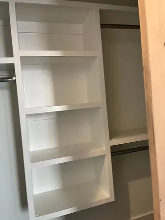 a white toilet sitting in a bathroom next to a wooden wall