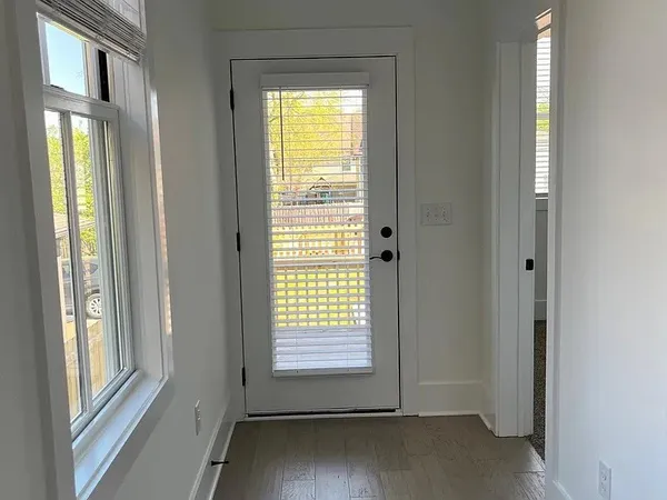 a front view of white house with glass windows
