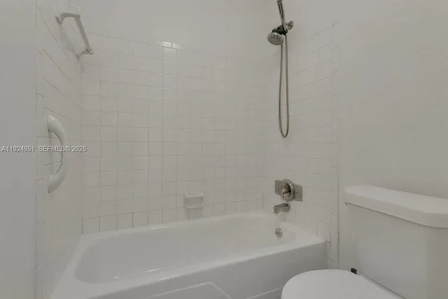 a bathroom with a bathtub and a toilet