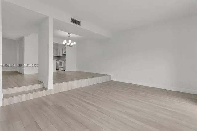 wooden floor in an empty room with a mirror