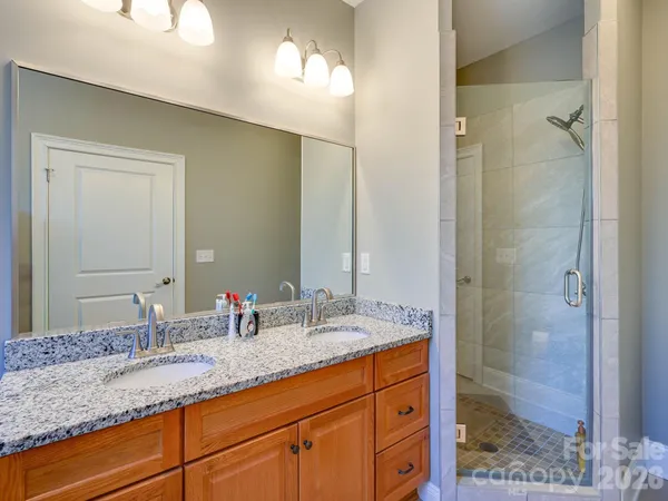 a bathroom with double sink and a mirror