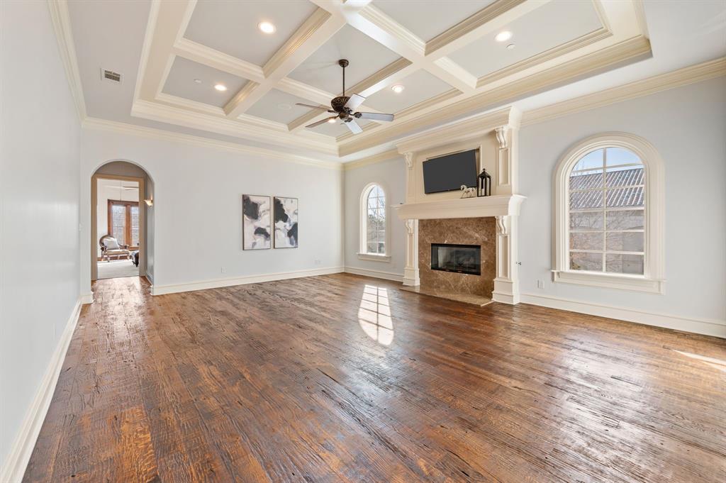 61 Piazza Lane Colleyville, TX 76034 - Photo 24 of 40 Upstairs living room with arched walkways, ceiling fan, dark wood-type flooring, a fireplace, and coffered ceiling