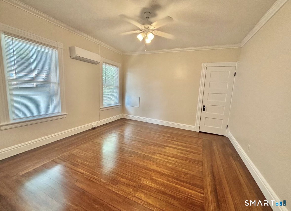 142 Broad Street Norwich, CT 06360 - Photo 14 of 26 wooden floor in an empty room with a window