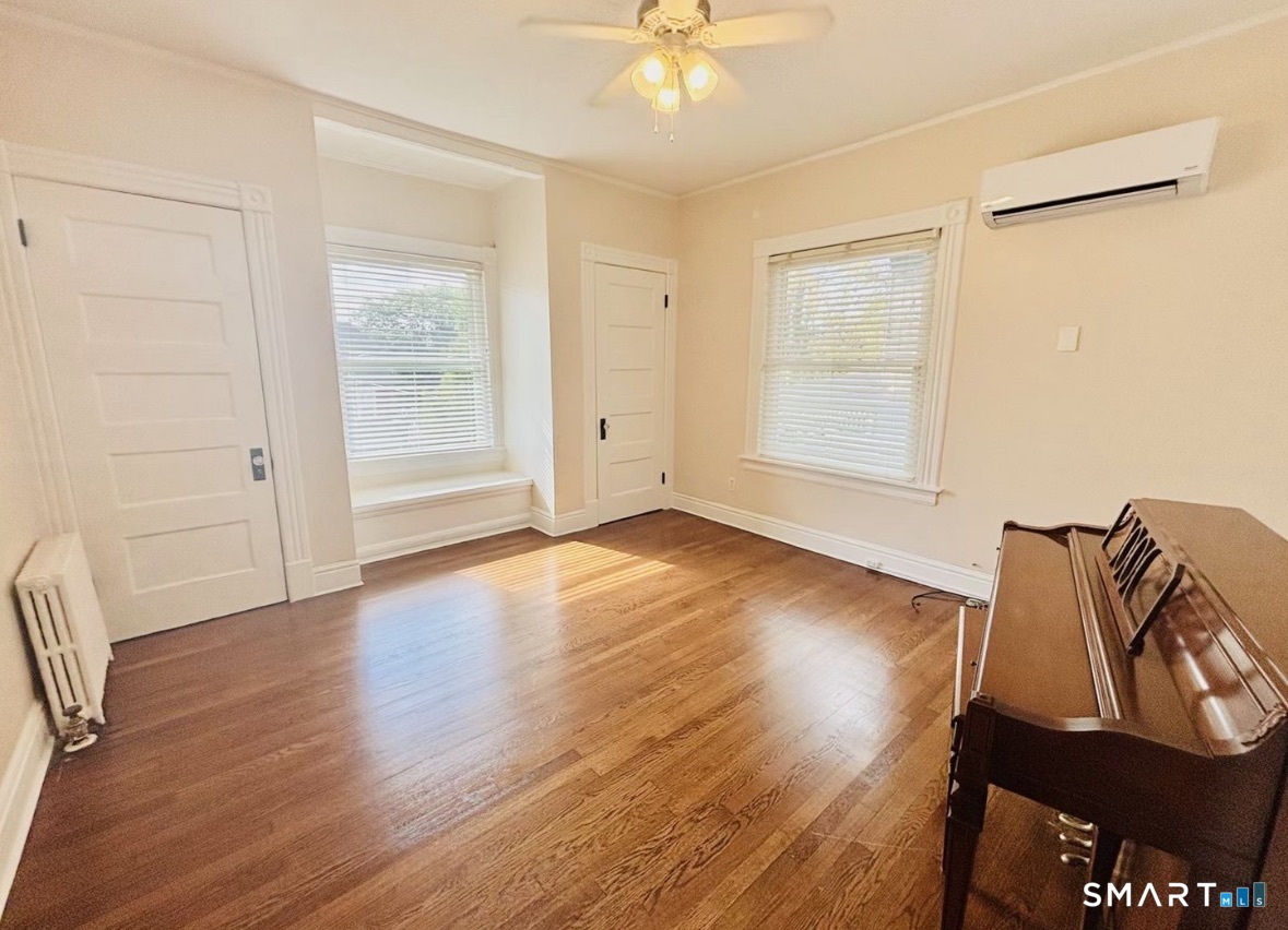 142 Broad Street Norwich, CT 06360 - Photo 15 of 26 an empty room with wooden floor and windows