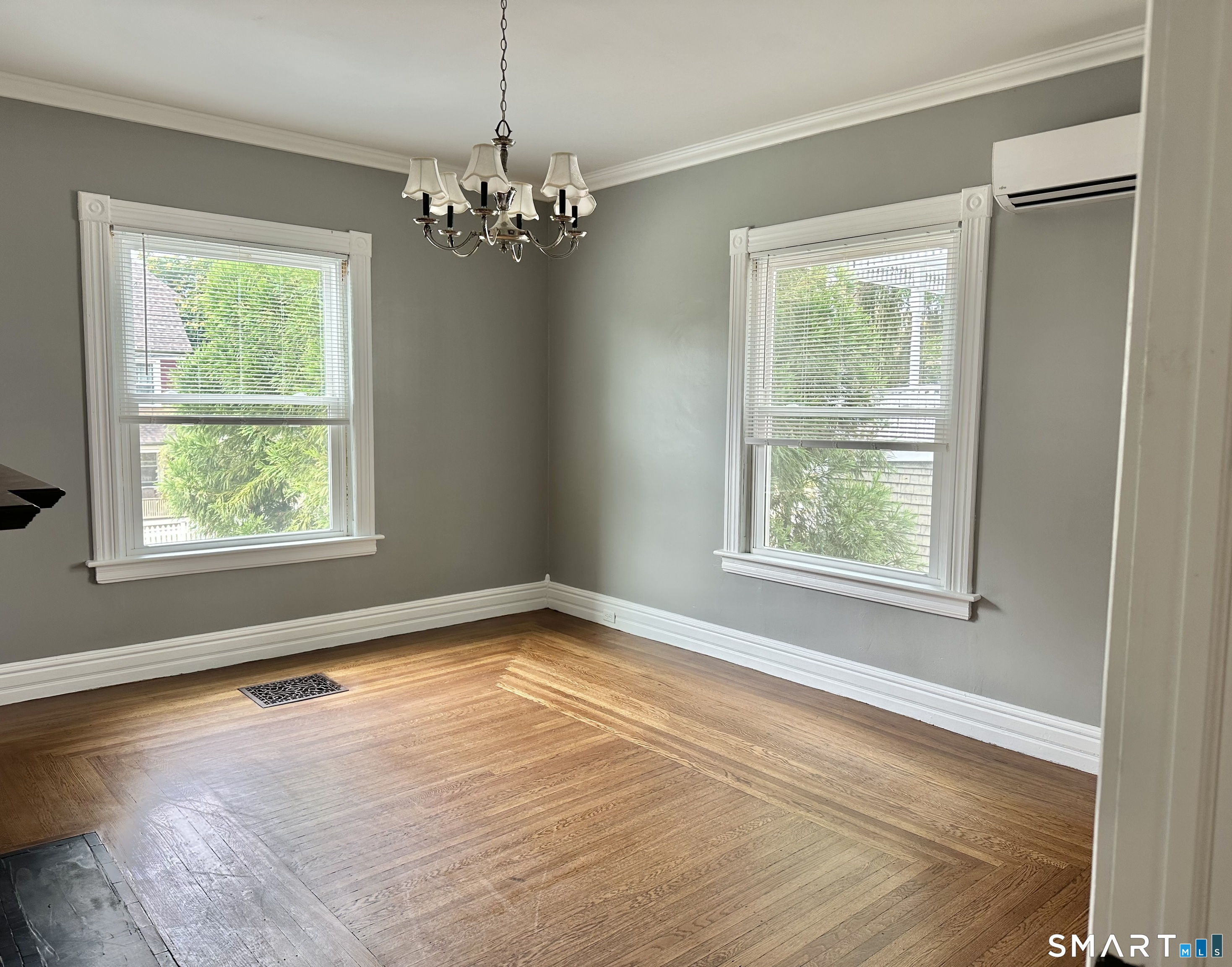 142 Broad Street Norwich, CT 06360 - Photo 18 of 26 a view of an empty room with wooden floor and a window