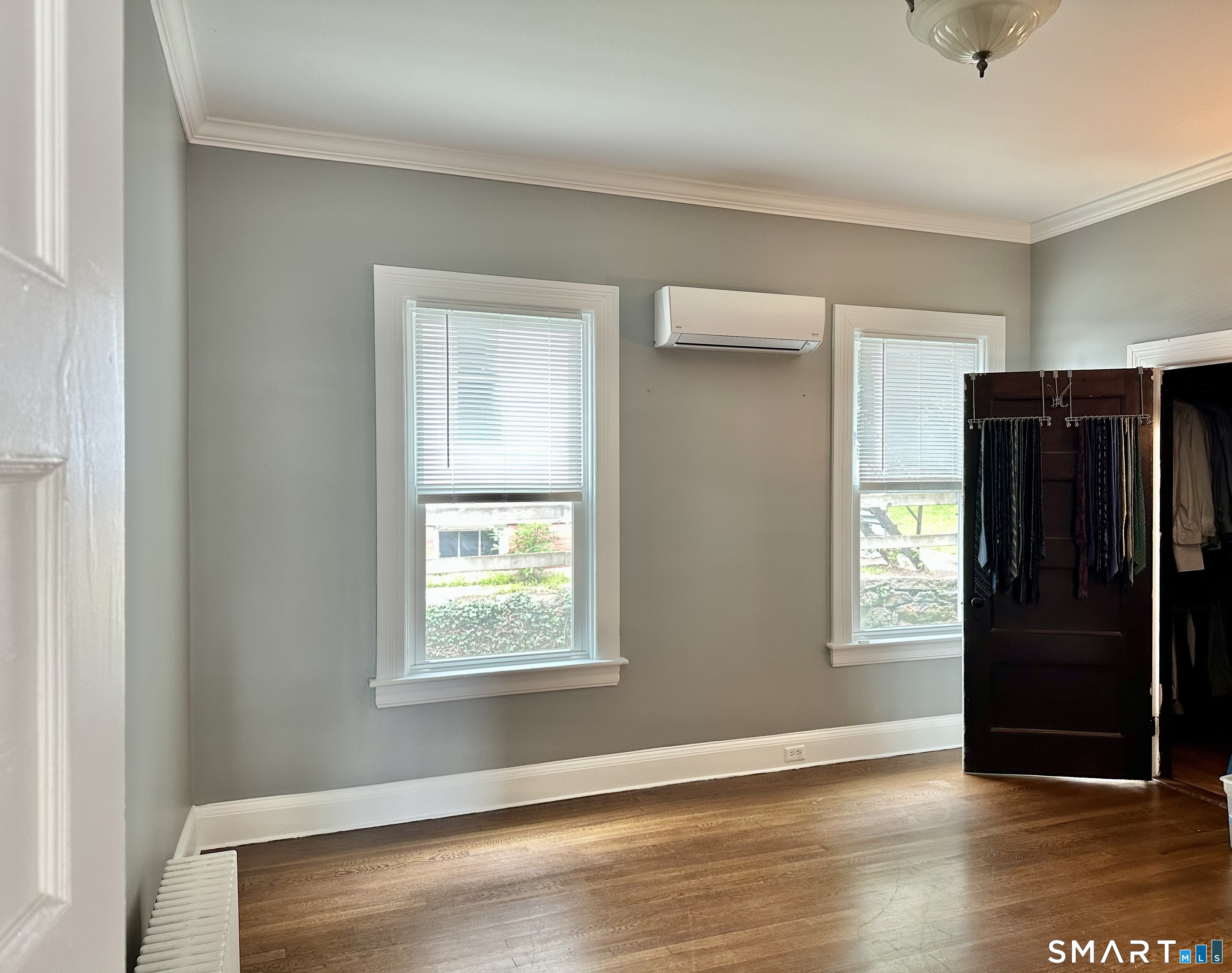 142 Broad Street Norwich, CT 06360 - Photo 19 of 26 a view of an empty room with window and wooden floor