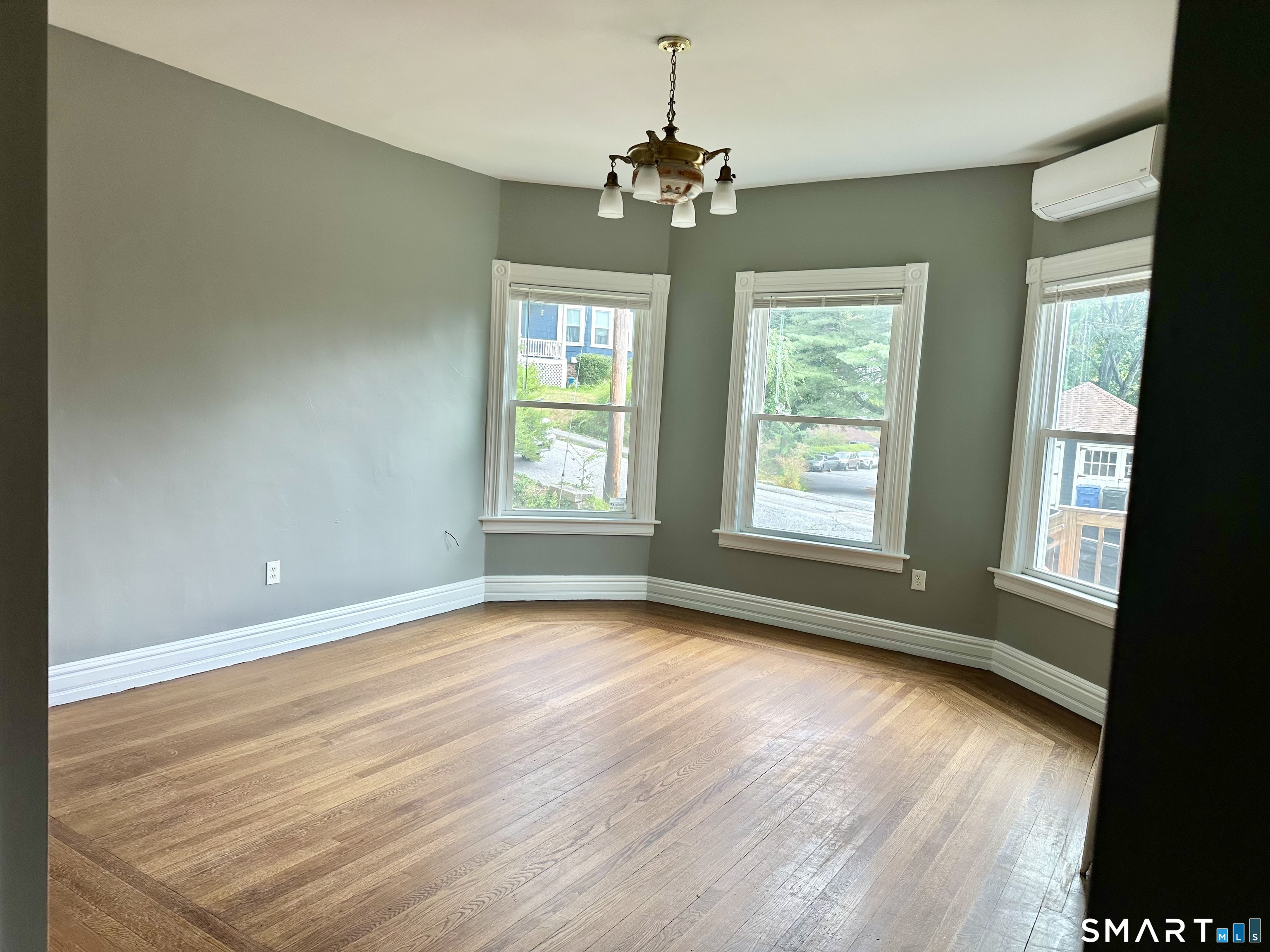 142 Broad Street Norwich, CT 06360 - Photo 20 of 26 a view of an empty room with wooden floor and a window