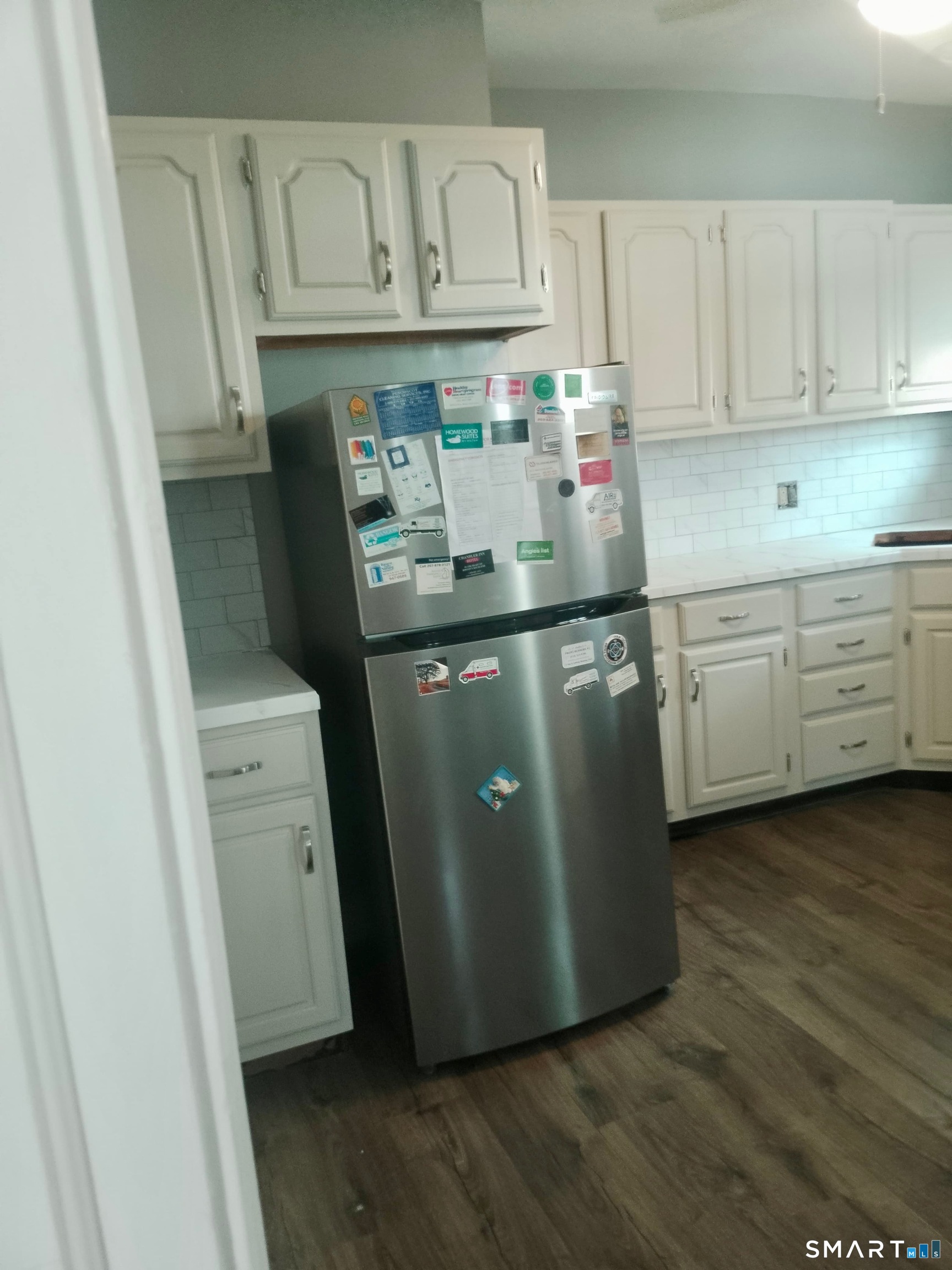 142 Broad Street Norwich, CT 06360 - Photo 23 of 26 a kitchen with stainless steel appliances granite countertop a refrigerator a sink and white cabinets