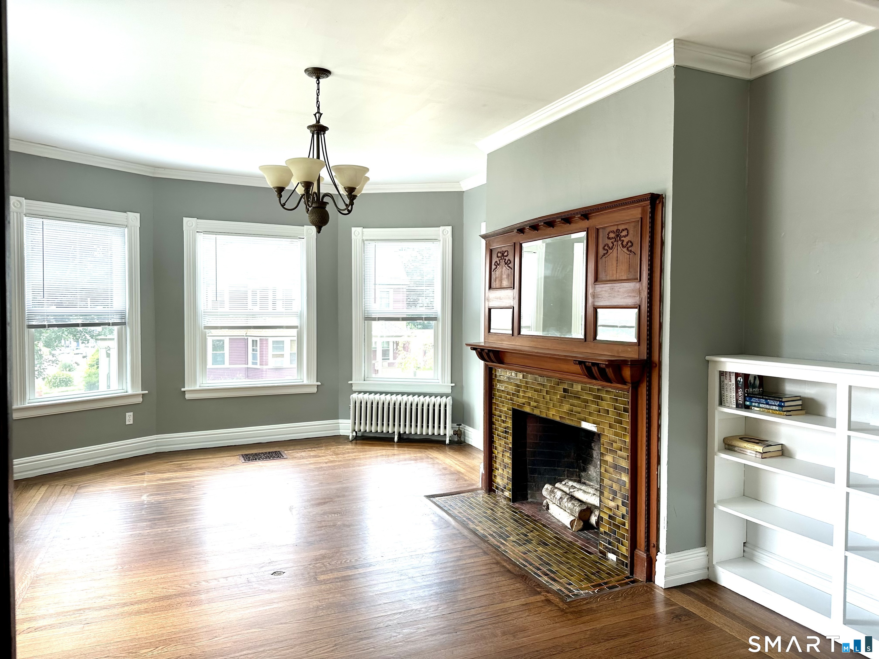 142 Broad Street Norwich, CT 06360 - Photo 24 of 26 a view of an empty room with a fireplace and a window