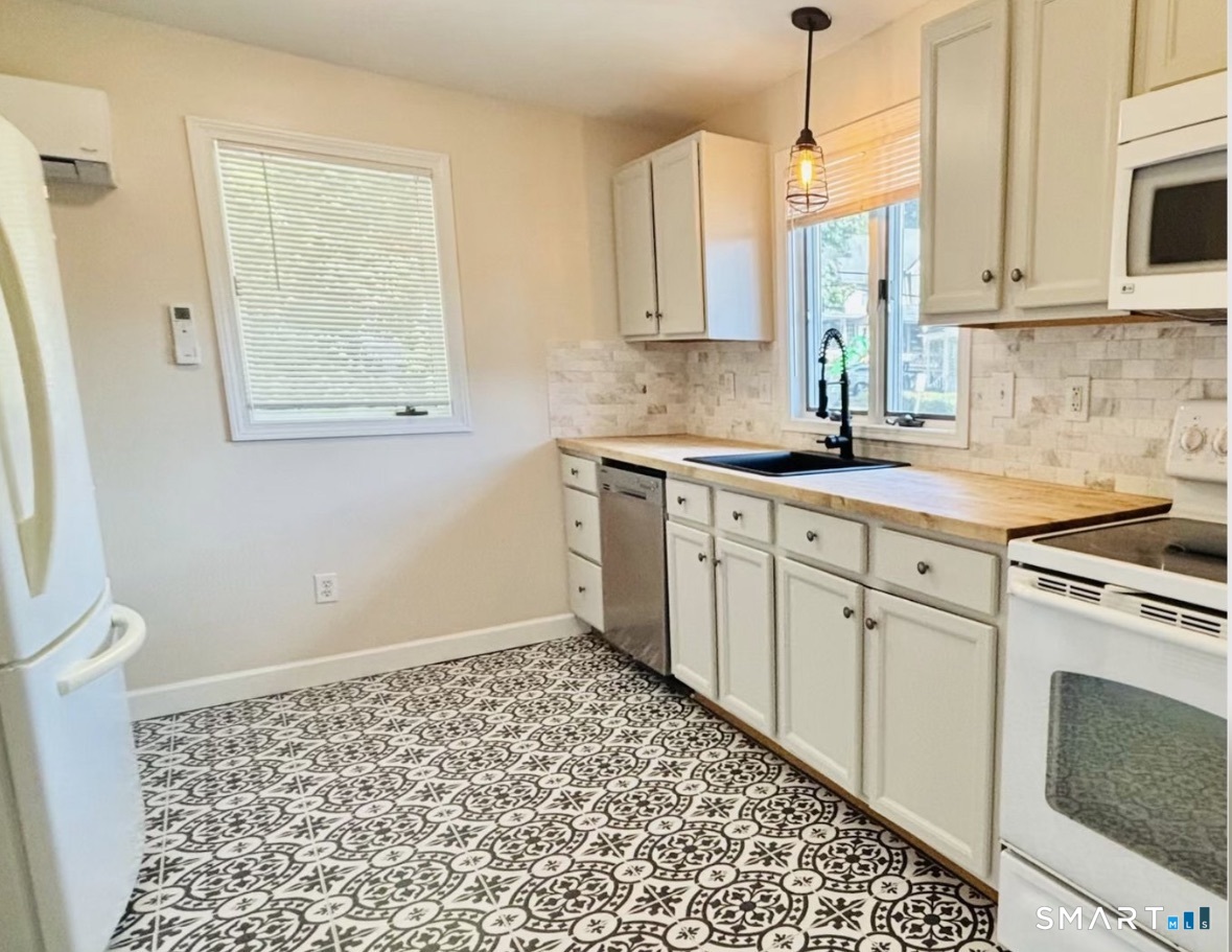 142 Broad Street Norwich, CT 06360 - Photo 5 of 26 a kitchen with a sink cabinets and window