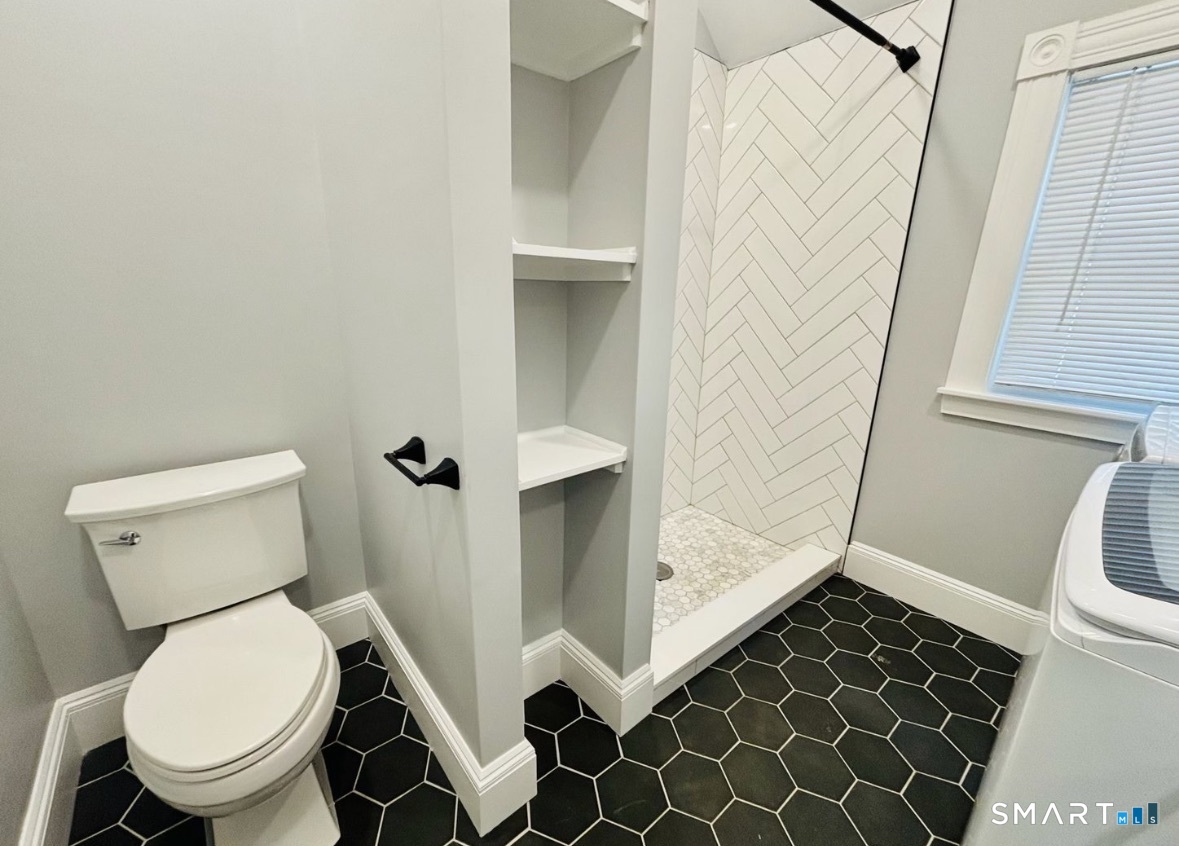 142 Broad Street Norwich, CT 06360 - Photo 7 of 26 a bathroom with a toilet and a shower