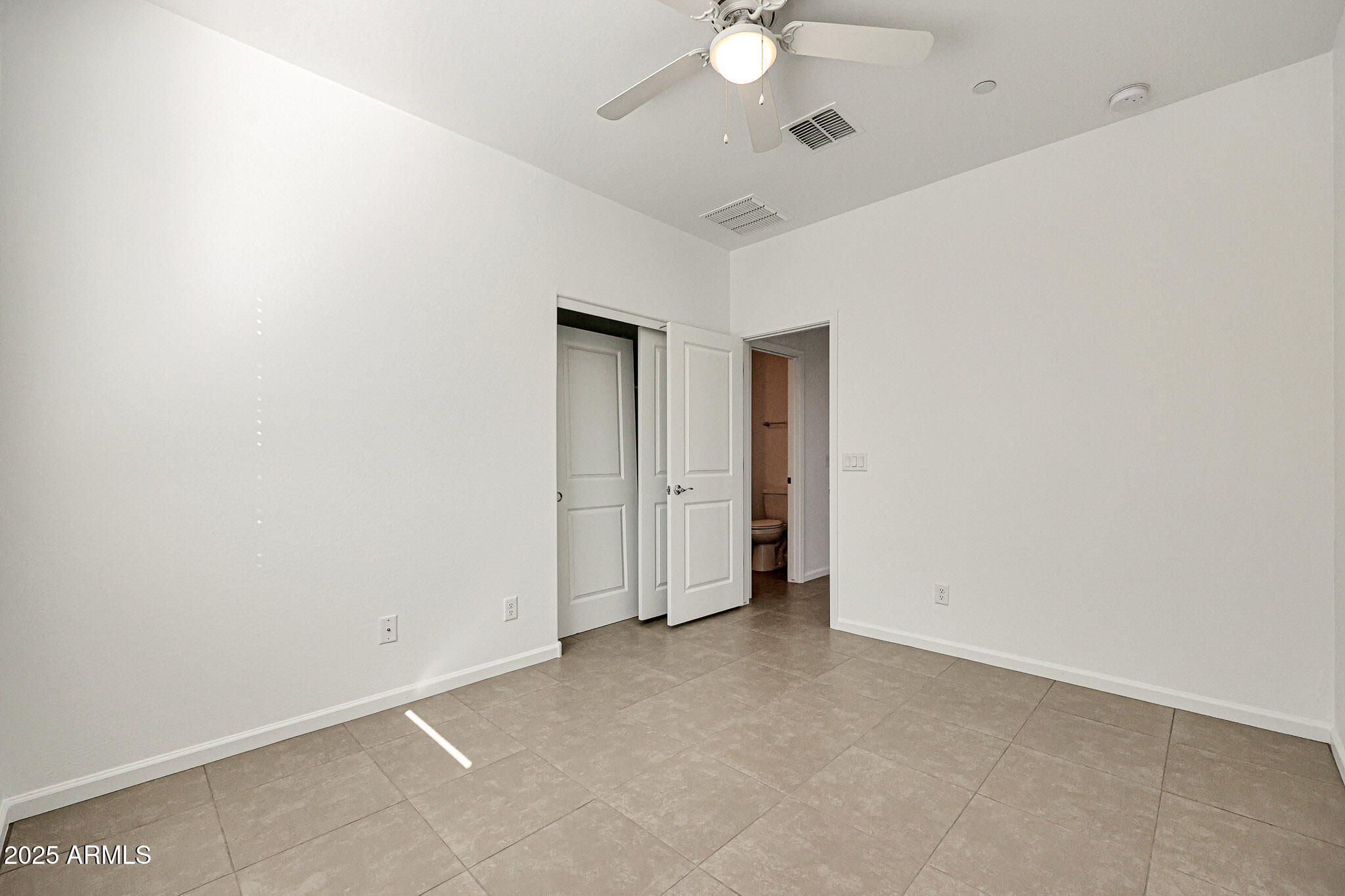 12429 West Midway Avenue Glendale, AZ 85307 - Photo 13 of 22 an empty room with a ceiling fan and a window