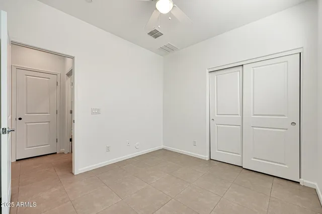 an empty room with a ceiling fan