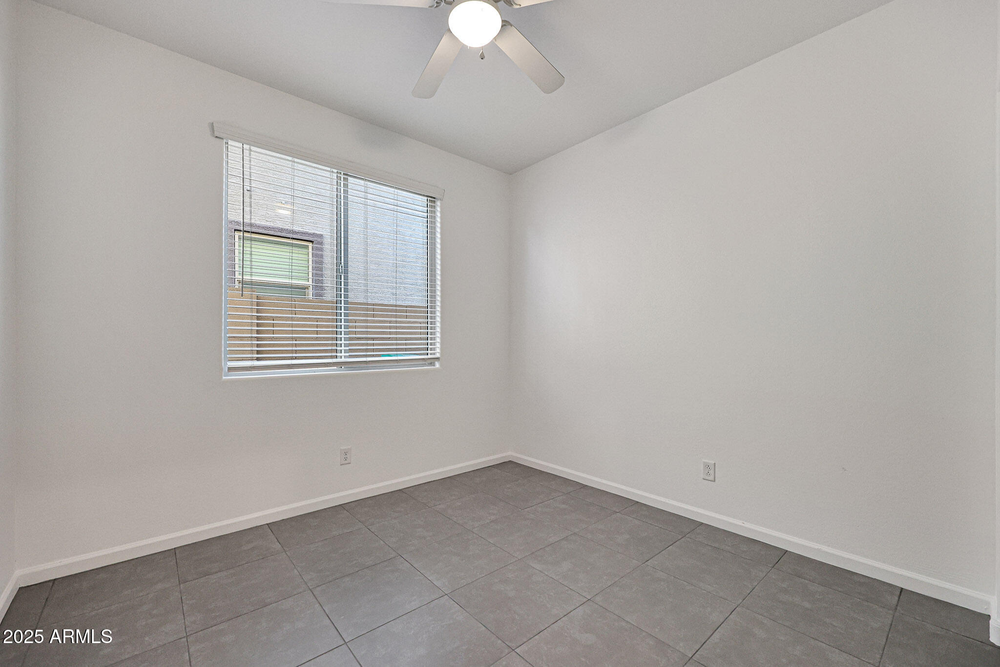 12429 West Midway Avenue Glendale, AZ 85307 - Photo 16 of 22 an empty room with a chandelier fan and windows