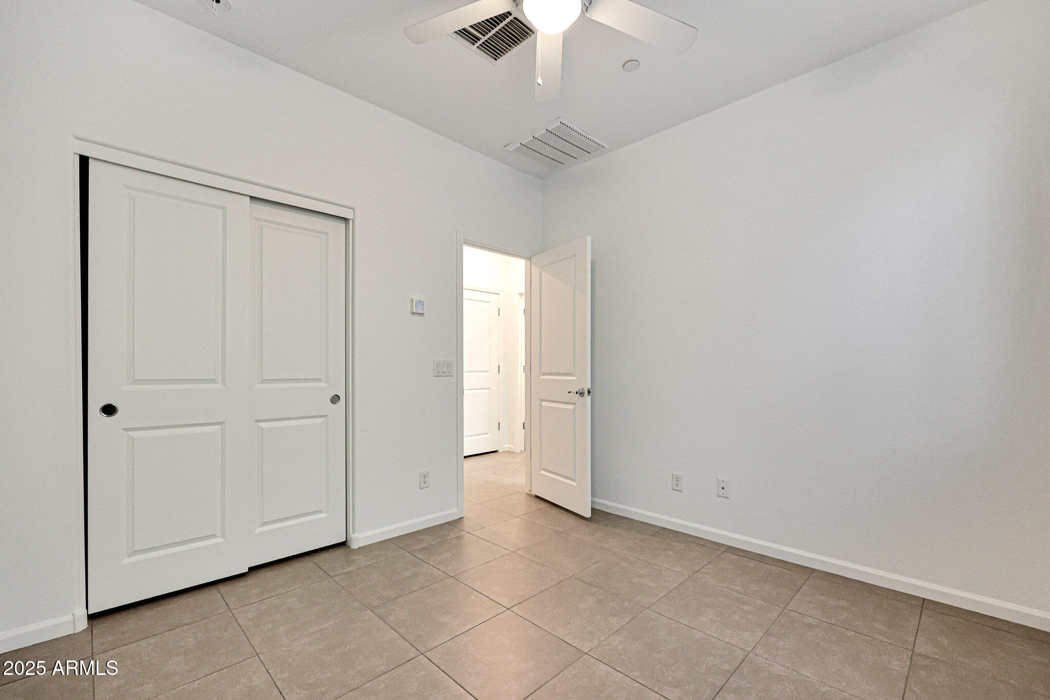 12429 West Midway Avenue Glendale, AZ 85307 - Photo 17 of 22 an empty room with chandelier fan and windows