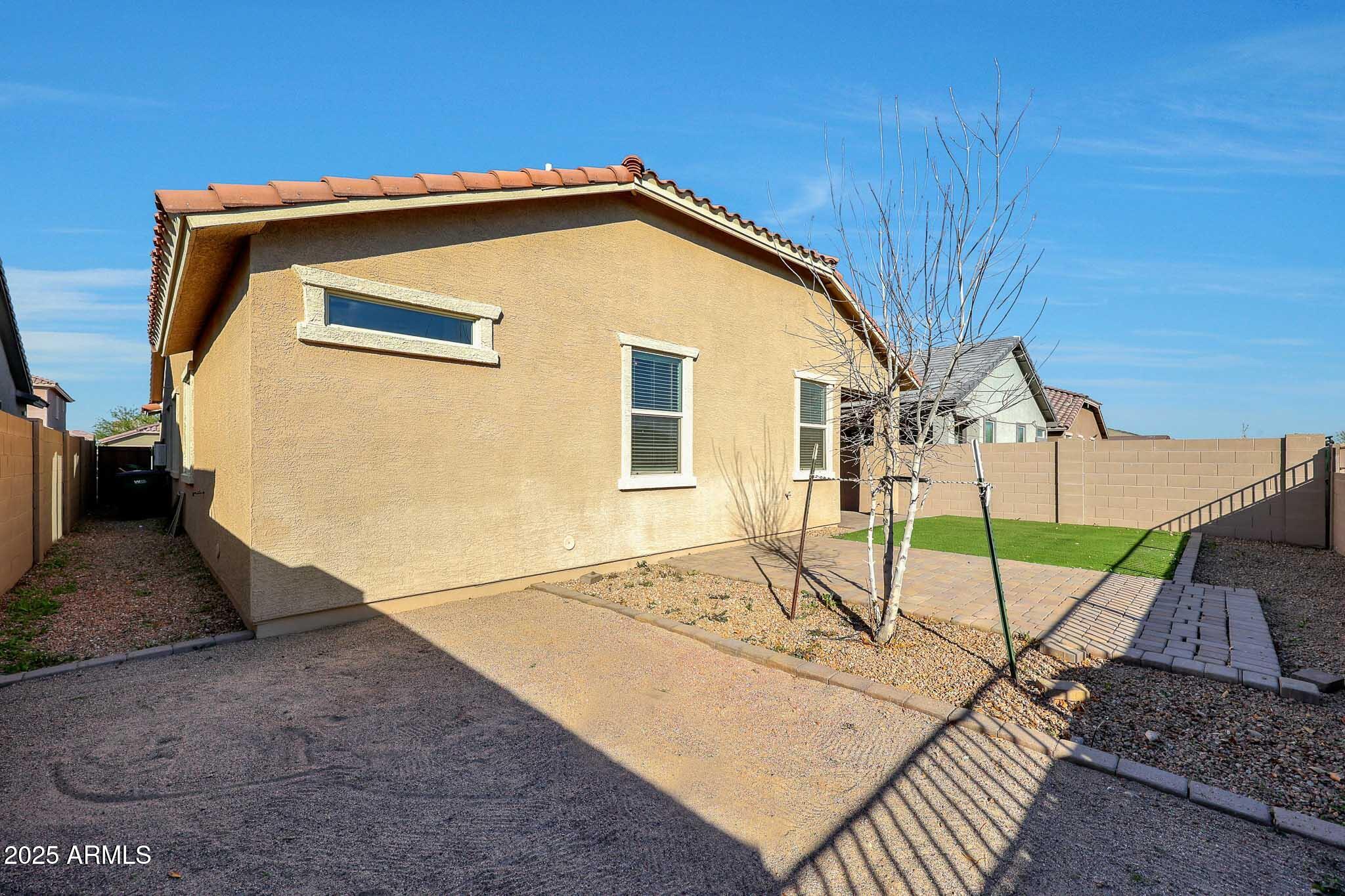 12429 West Midway Avenue Glendale, AZ 85307 - Photo 21 of 22 a view of a house with wooden fence