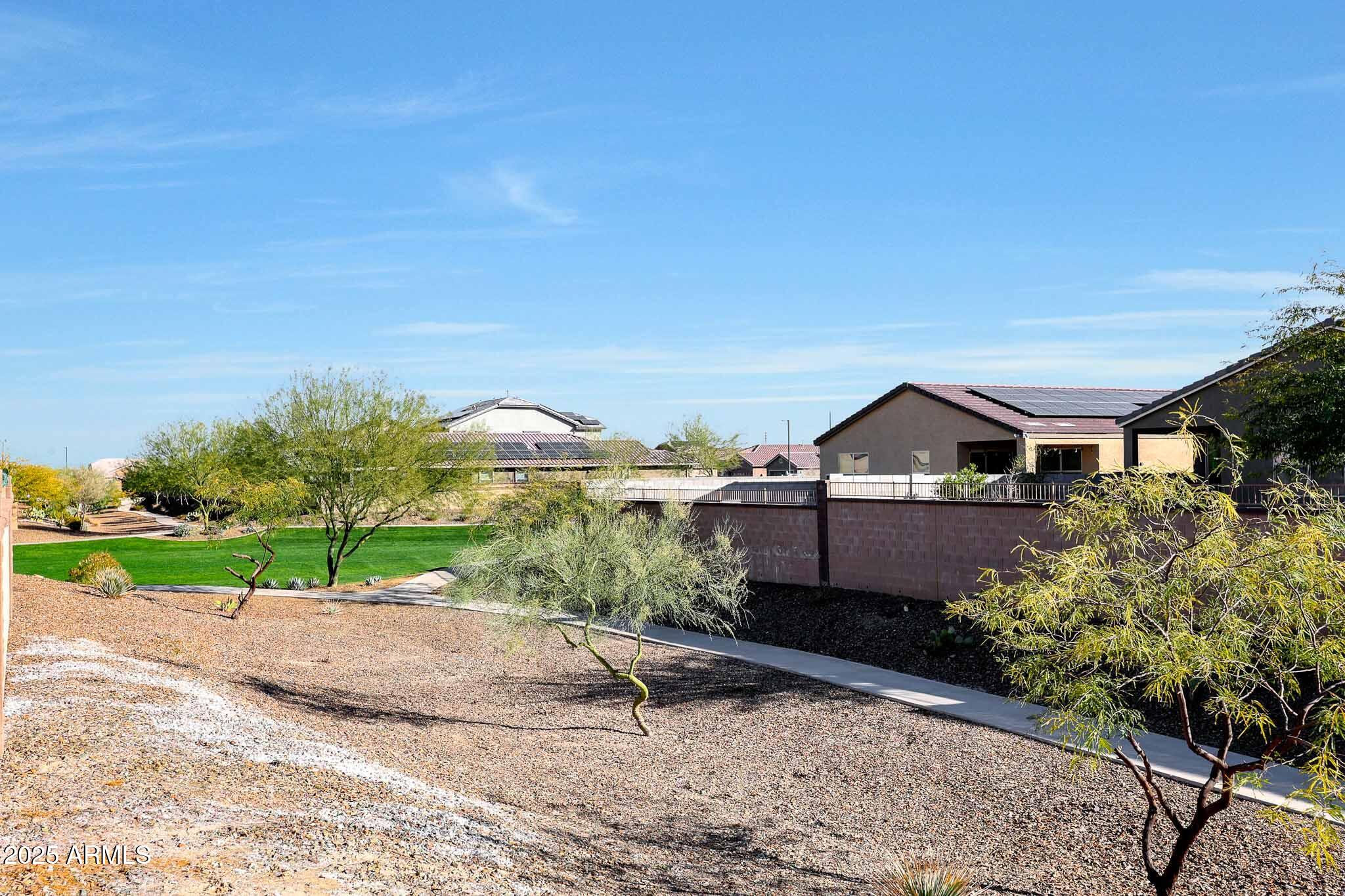 12429 West Midway Avenue Glendale, AZ 85307 - Photo 22 of 22 a house with green field in front of it