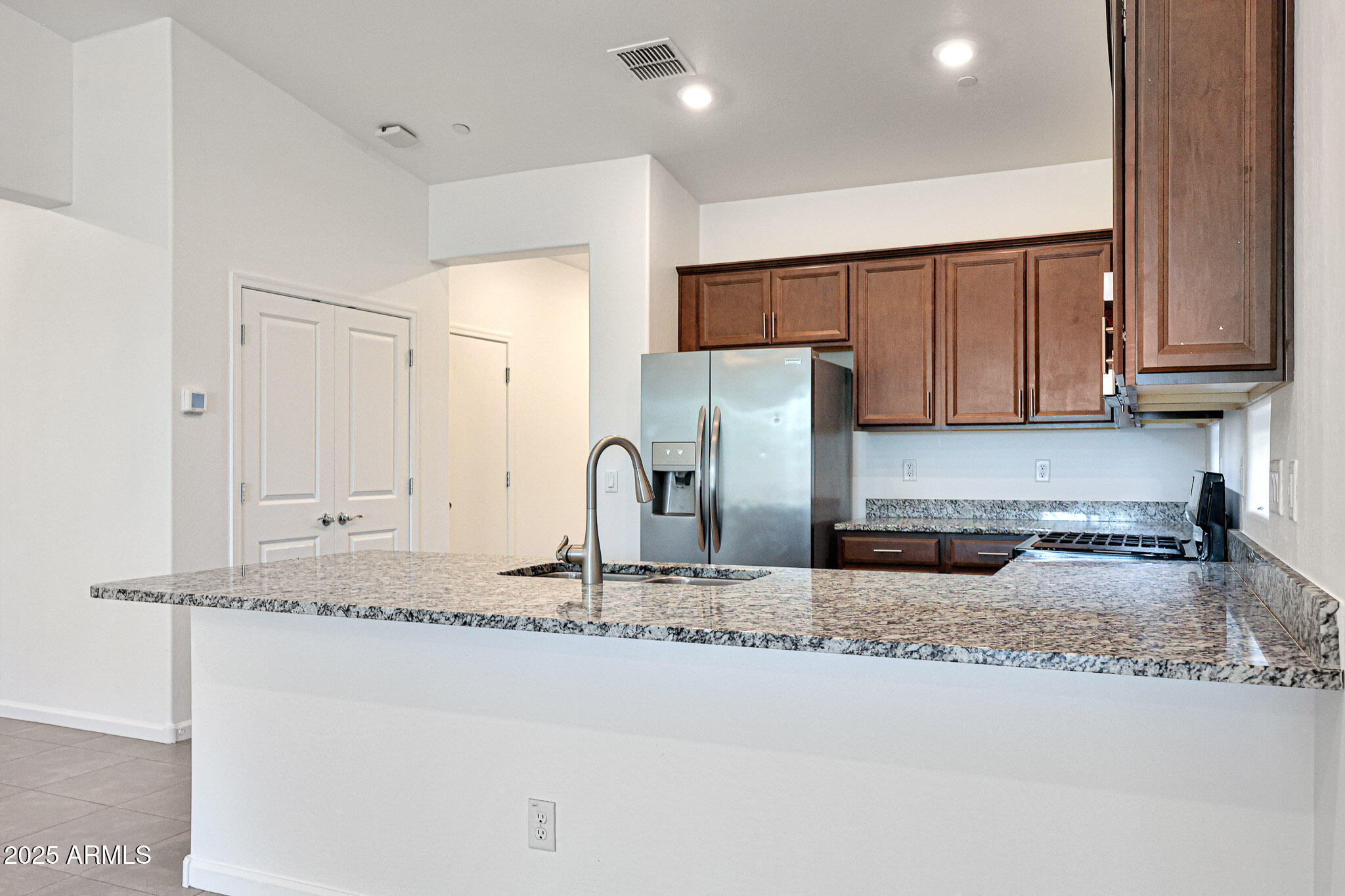 12429 West Midway Avenue Glendale, AZ 85307 - Photo 4 of 22 a kitchen with stainless steel appliances granite countertop a sink a refrigerator and a granite counter tops