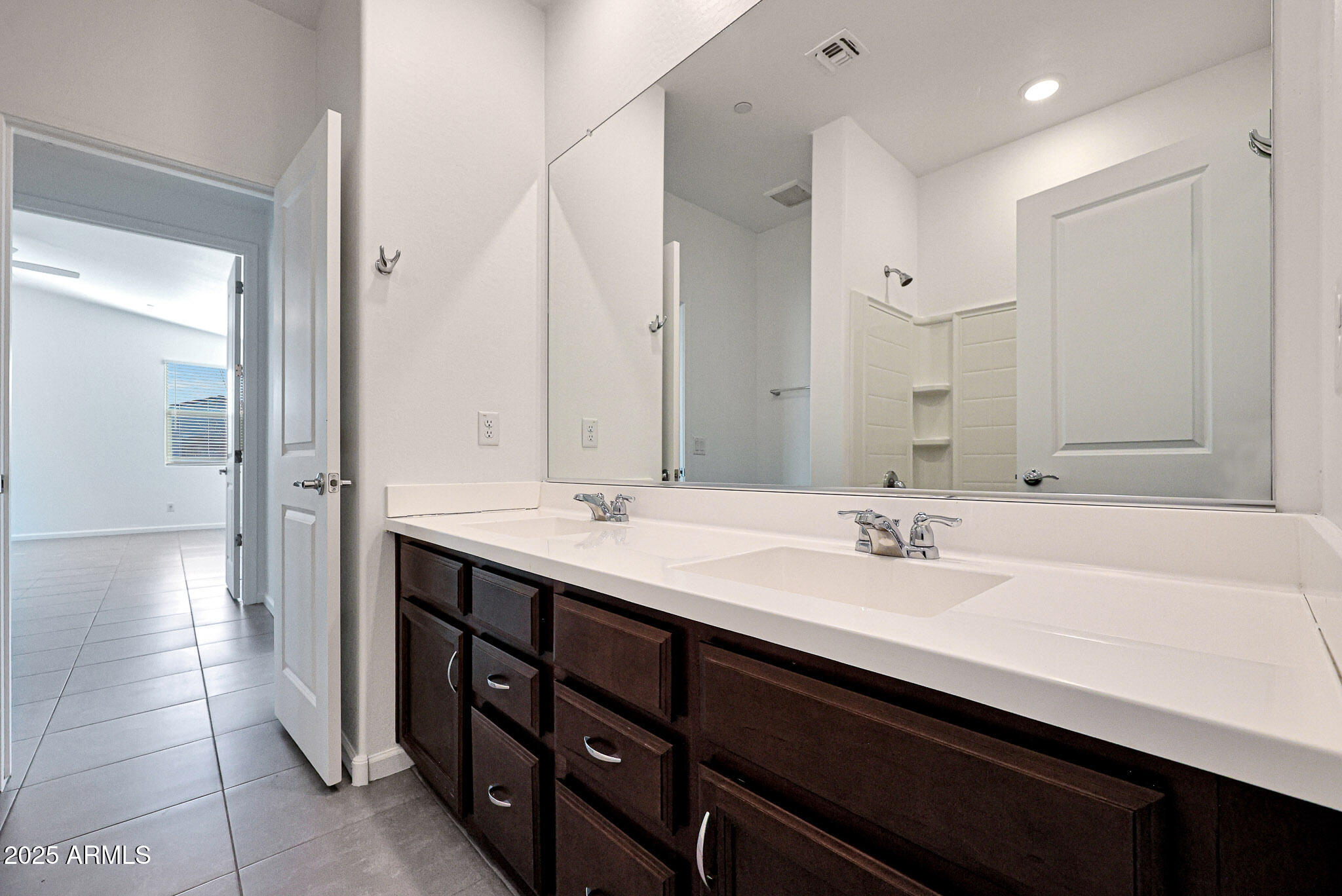 12429 West Midway Avenue Glendale, AZ 85307 - Photo 7 of 22 a bathroom with a double vanity sink a mirror and a bathtub