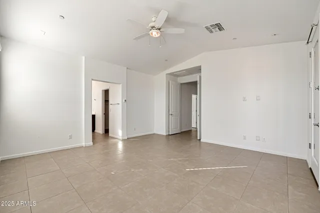 a view of an empty room with a ceiling fan