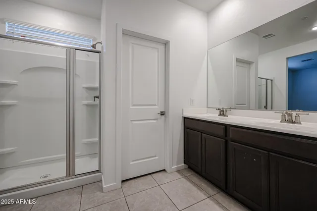 a bathroom with a double vanity sink and mirror