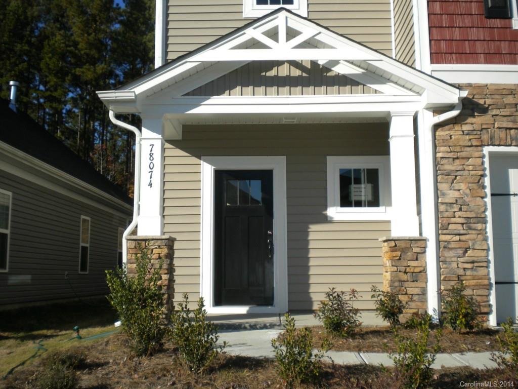 78074 Rillstone Drive, Unit 196 Lancaster, SC 29720 - Photo 2 of 24 a view of a house with a yard and garage