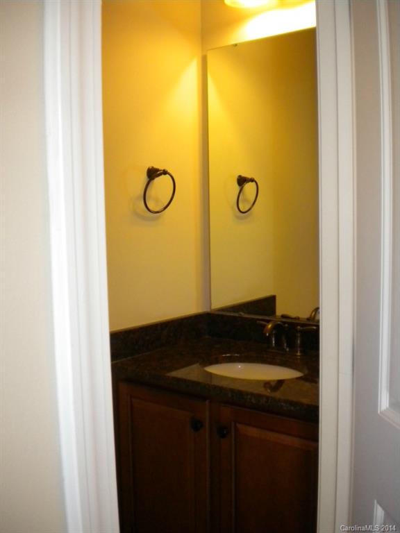 78074 Rillstone Drive, Unit 196 Lancaster, SC 29720 - Photo 3 of 24 a bathroom with a granite countertop sink and a mirror