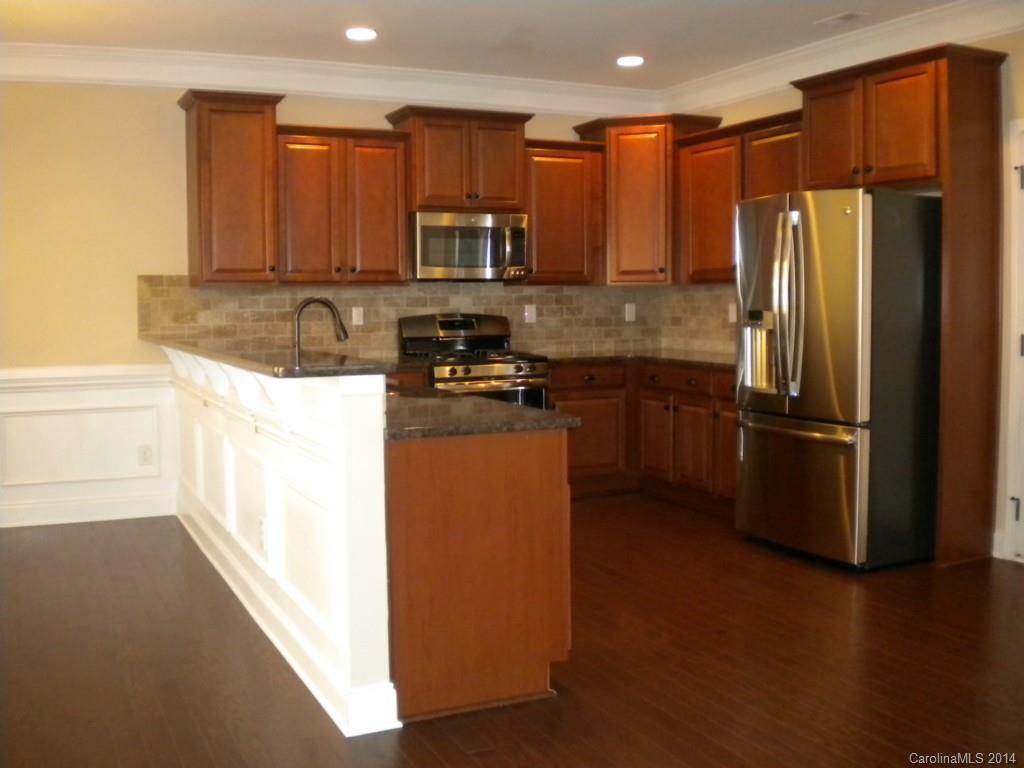 78074 Rillstone Drive, Unit 196 Lancaster, SC 29720 - Photo 9 of 24 a kitchen with stainless steel appliances granite countertop a refrigerator a stove a sink and a microwave