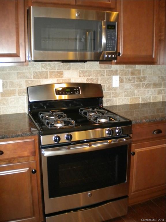 78074 Rillstone Drive, Unit 196 Lancaster, SC 29720 - Photo 10 of 24 a stove top oven sitting inside of a kitchen