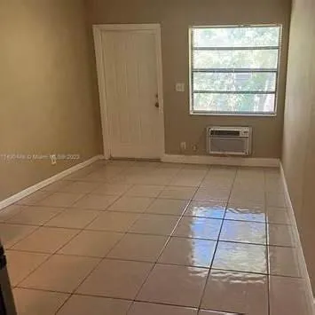 an empty room with a empty space and window