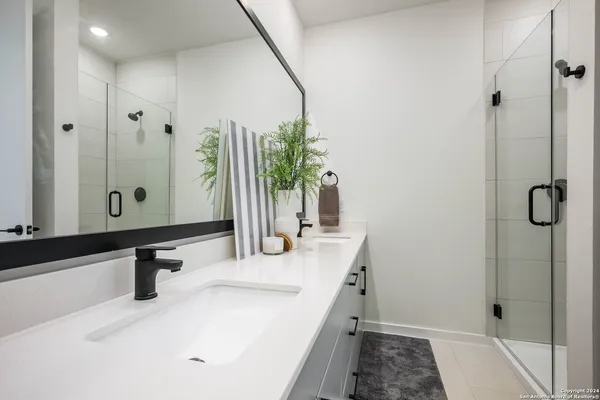 a bathroom with a double vanity sink and a mirror