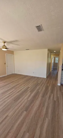 a view of a room with wooden floor