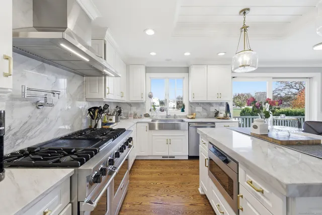 a kitchen with stove a sink and cabinets