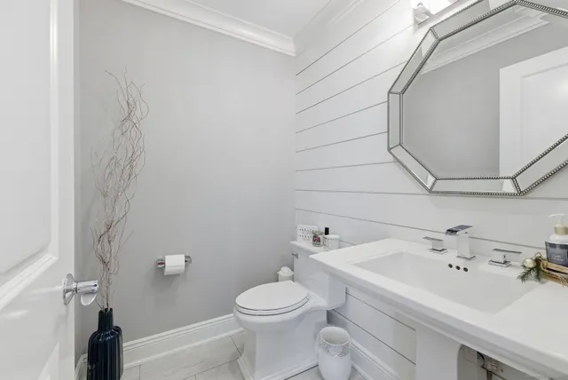 a bathroom with a sink mirror vanity and toilet