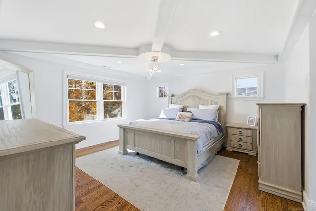 a bedroom with a large bed and a window