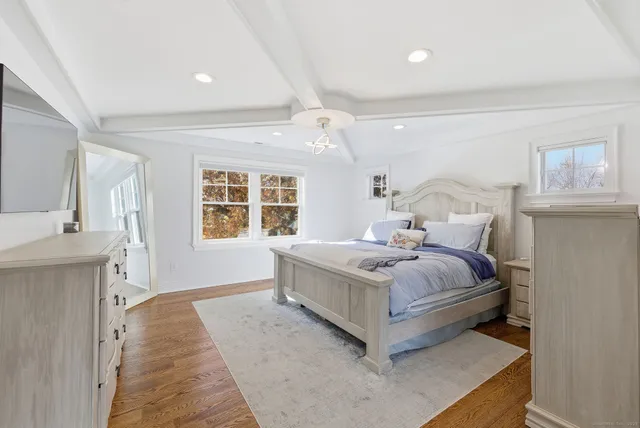 a living room with a bed furniture and a window