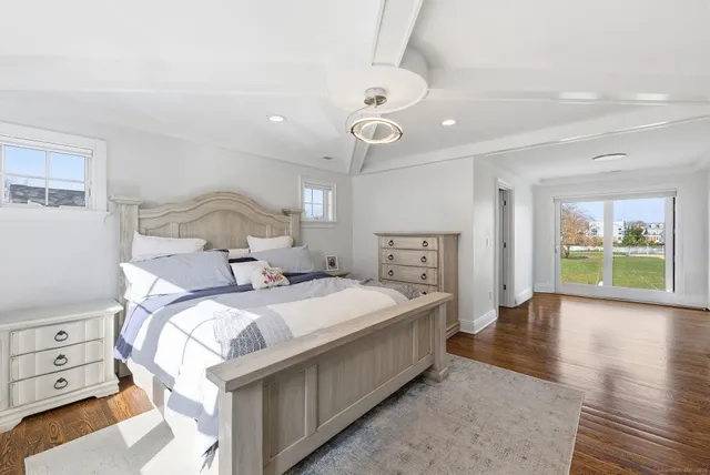 a bedroom with a large bed and a window