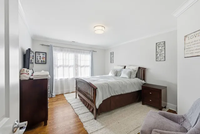 a bedroom with a bed and a potted plant