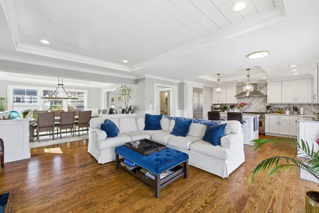 a living room with furniture white walls and wooden floor
