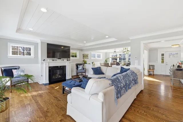 a living room with furniture large window and a fireplace