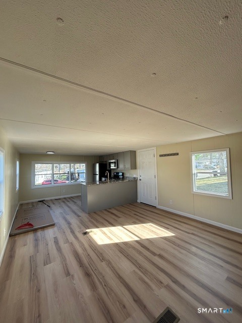 18 Fairway Drive Windham, CT 06256 - Photo 3 of 15 a view of a hallway with wooden floor and a refrigerator