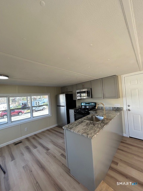 18 Fairway Drive Windham, CT 06256 - Photo 6 of 15 a kitchen with stainless steel appliances granite countertop a stove a sink and a refrigerator