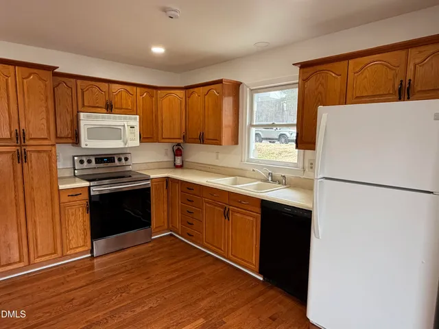 a kitchen with a refrigerator sink and stove